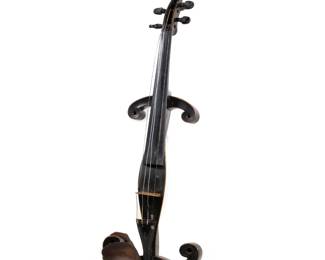 19TH C. PRACTICE VIOLIN | Circa late 19th century black painted wood practice violin, with an Aubert & Mirecourt fitted violin bridge, made in France
 - l. 23.5 x w. 8 in.