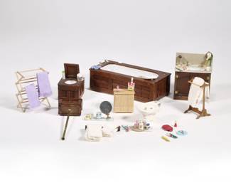 DOLLHOUSE BATHROOM FURNITURE | Miniature dollhouse bathroom fixtures and furniture, including a wood paneled bath tub, toilet, sink, porcelain bidet stamped "Wonderland Originals, Ltd. 1980", three towel racks, a wicker hamper, two glass shelves, and other loose miniature bathroom accessories
 - l. 6.25 x w. 3 x h. 1.75 in. (tub)