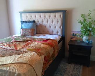 Guest bedroom features a queen sized bed set. 