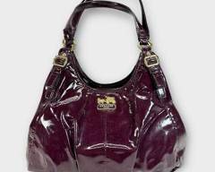 COACH Burgundy Patent Leather Slouchy Handbag with 3 Compartments and Gold Tone Hardware.
