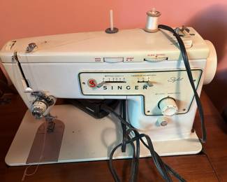 #115	Metal Singer Stylist Sewing machine in Cabinet	 $50.00 
