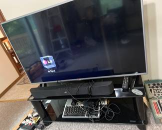 50 inch LG TV, Polk Audio Sound Bar, and Glass TV stand/mount
