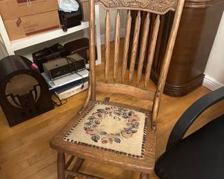 Antique rocker with needlepoint cushion