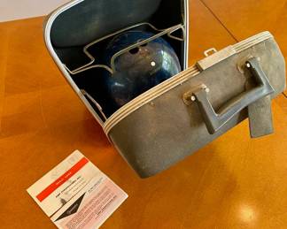 Lot 050-LR: Vintage Columbia 300-White Dot Bowling Ball w/Bag

Features: 
•	Weight unknown, marked with “9A98447”
•	Engraved J.S.C.
•	Vintage Sears, Roebuck carrying case 

Condition: Bowling ball in good pre-owned condition. Bag exhibits age and use-related wear. 

