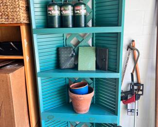 very nice blue corner shelf, propane tanks, flower pots, furniture