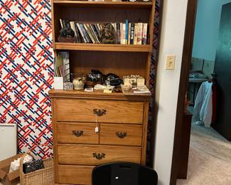 Very nice book shelf with some cameras and clocks