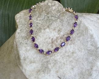 #64J - $295 Amethyst bracelet, 10kt gold. 6.5 grams