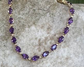 #64J - $295 Amethyst bracelet, 10kt gold. 6.5 grams 