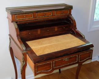 An open view of the antique 19th Century "bureau de dame" desk with cylinder movement top opened, interior folded out resting on drawer to provide writing surface