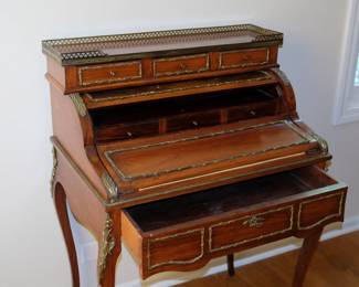 The locking lid opened, showing three interior small drawers, the main drawer extended