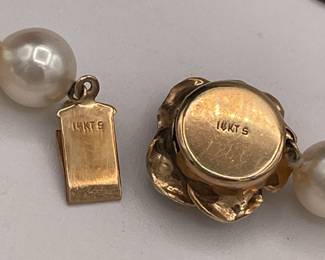 Closeup of beautifully matched cultured pearl choker necklace with 14k gold rose form clasp