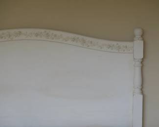 Closeup of vintage painted bedframe, headboard and footboard