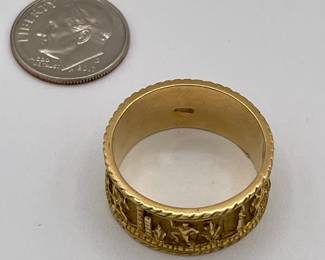 Closeup of heavy gold Middle Eastern ring, bas relief figures around the band