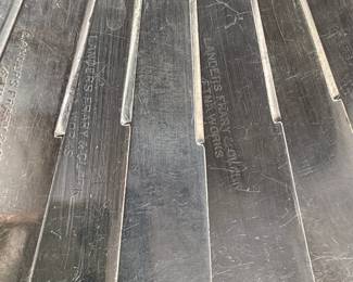 Closeup of blades on the set of 9 mother of pearl handle luncheon knives with sterling silver collars. Landers Frary Clark Aetna Works