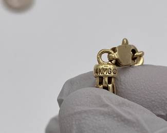 Closeup of 14k gold necklace clasp and makers mark