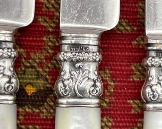 Closeup of Wm. Rogers Mfg. Co. mother of pearl handled sterling collared knives
