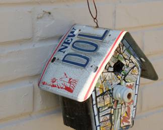 Another view of hand-made "New York" themed birdhouse, mosaic work and license plate