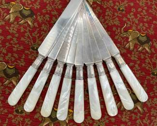 A set of 9 mother of pearl handle luncheon knives with sterling silver collars. Landers Frary Clark Aetna Works