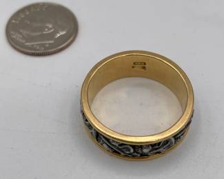 Closeup view of 18k gold ring with central band of silver sculptured oak leaves and acorns