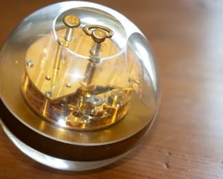 Closeup of Tiffany & Company Paperweight table clock, c. 1965, acrylic, brass, enameled brass