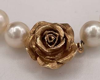 Closeup of beautifully matched cultured pearl choker necklace with 14k gold rose form clasp