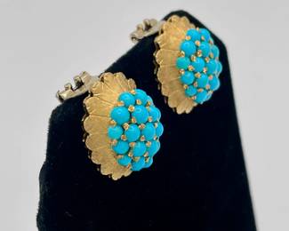 Closeup of 18k gold and turquoise clip earrings, made in Italy