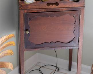 Georgian bedside cabinet / nightstand, standing on tapered legs and features a shaped gallery with pierced handles