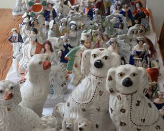 Very large collection of porcelain and ceramic figurines including antique porcelain Staffordshire dog figurines, Toby Jugs, spill vases, sailors, and more