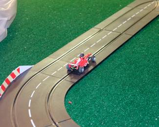 Closeup of Carrera 132 Formula Champions race track set with two cars and controller