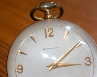 Closeup of Tiffany & Company Paperweight table clock, c. 1965, acrylic, brass, enameled brass
