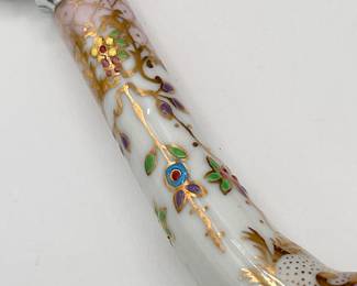 Closeup of Sheffield England stainless steel cake knife, enameled porcelain handle
