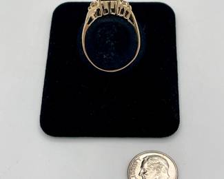 Side view of 14k gold ring with large very dark sapphire and small side diamonds