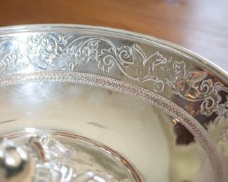 Closeup of silver plated bowl, decorated with the figure of Hercules as a child. The base enscribed Christofle & Cie, Tresor D'Hildesheim, Fac-simile Galvanique