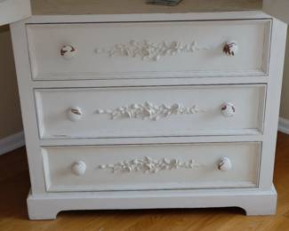Closeup of drawers in the base of vintage painted wardrobe