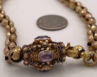 Another closeup of 19th Century pinchbeck guard chain / necklace with textured round links and an elaborate barrel clasp with cannetille embellishment and set with amethysts