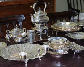 Stunning silver plate including shell-shaped seafood platter,  teapot on matching heating stand, various serving utensils and chafing dishes