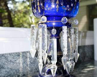 Another view of late 19th Century antique English Victorian blue glass mantle luster, waisted column rising from round base, beautifully decorated with enameling and gilding, crenellated top and with a double row of seven well cut clear glass pendant spears