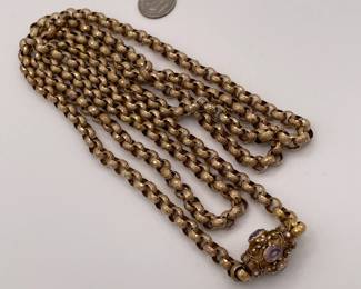 Another view of 19th Century pinchbeck guard chain / necklace with textured round links and an elaborate barrel clasp with cannetille embellishment and set with amethysts