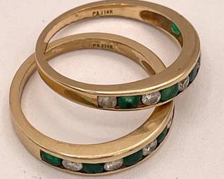 Closeup of pair of 14k gold, emerald and diamond stacking rings, P&J maker's mark