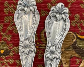 Elegant lily decoration on matching sterling serving spoons