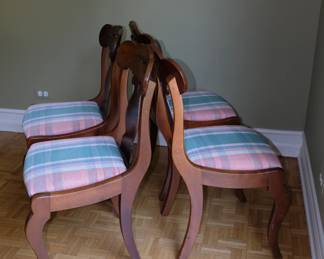 Side view of matched set of four vintage wooden chairs
