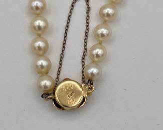 Reverse of clasp on cultured pearl bracelet with 14k gold heart-shaped clasp