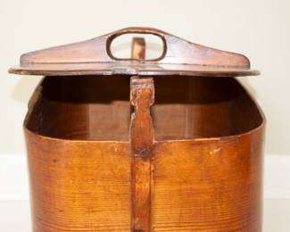 Another view of antique hand-crafted curved wooden lidded basket with handle and side latches