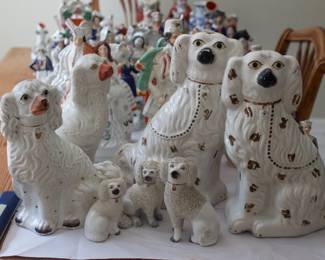 Several sizes of antique porcelain Staffordshire dog figurines lead the pack of a very large collection of porcelain and ceramic figurines