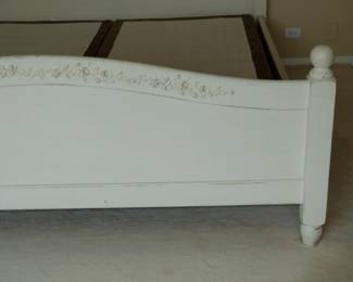 Closeup of vintage painted bedframe, headboard and footboard