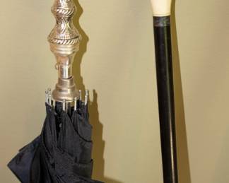 Closeup of umbrella - silver plate handle; walking stick with carved ivory or bone top