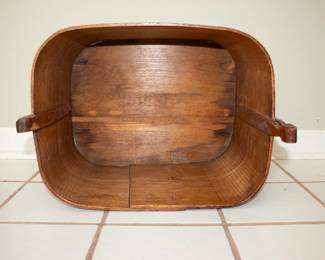 Another view of antique hand-crafted curved wooden lidded basket with handle and side latches