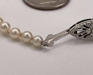 Closeup view of clasp on cultured pearl single strand necklace