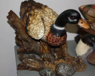 Cast wood mallard on log branch