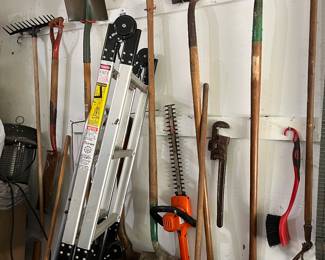 several garden tools, trimmers, electric chain saw